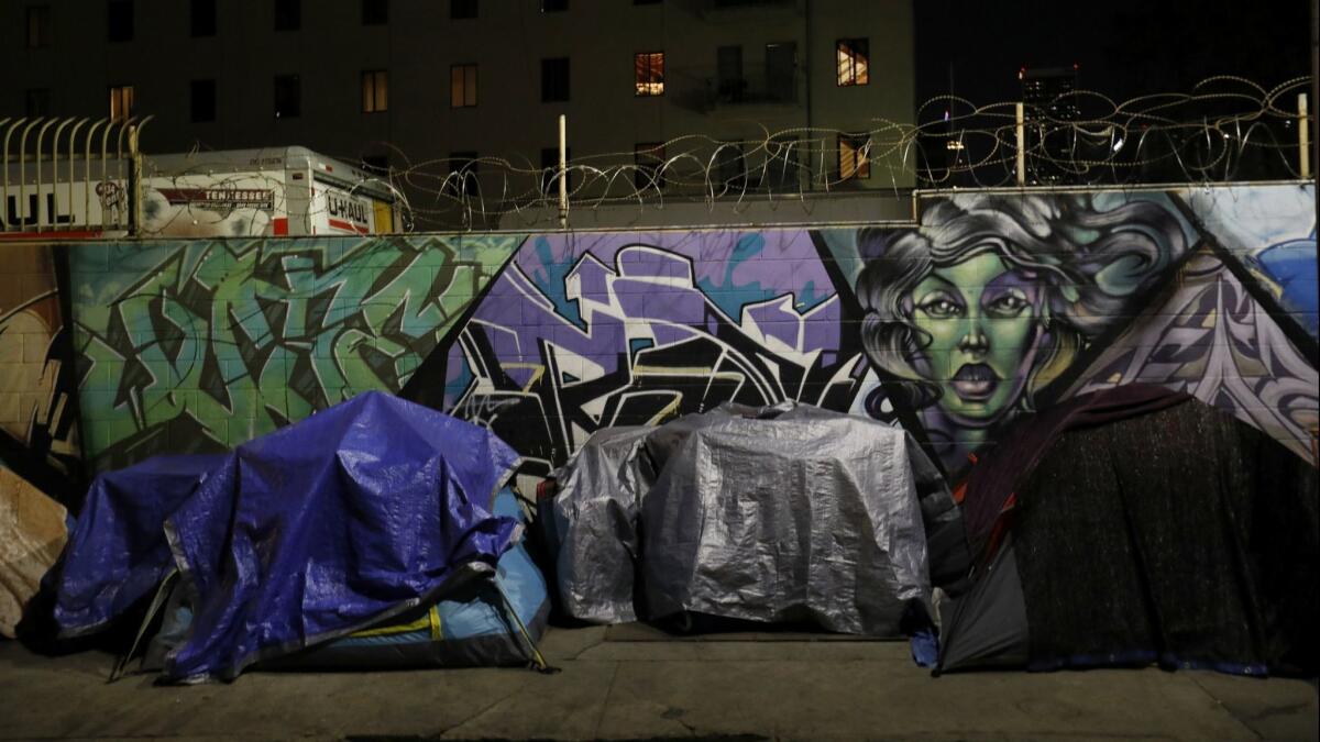Early morning before dawn, tents line San Julian Street in the skid row area of Los Angeles on Feb. 2, 2018.