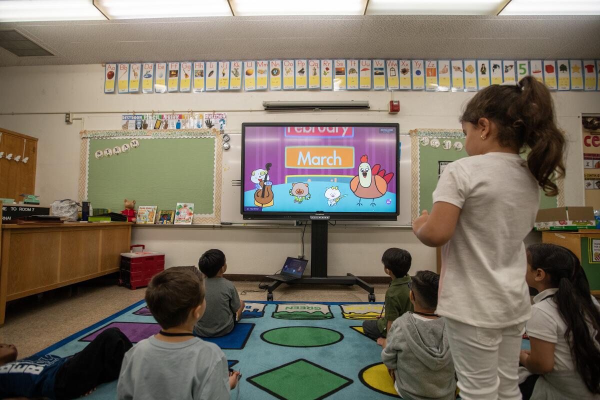 Children watch a video during a transitional kindergarten class.