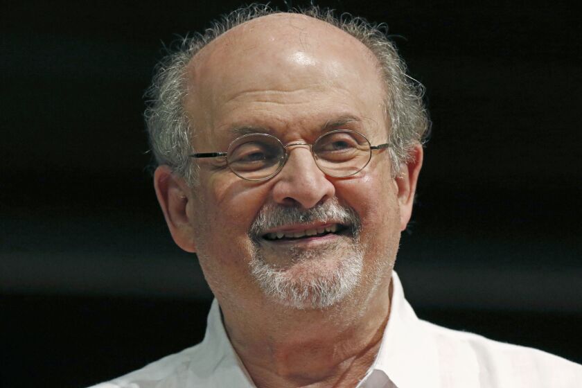 FILE - In a Saturday, Aug. 18, 2018 file photo, author aSalman Rushdie laughs as he highlights his own start as a writer during the Mississippi Book Festival in Jackson, Miss. Booker Prize winners Salman Rushdie and Margaret Atwood are contenders again for the coveted fiction trophy. Rushdie, who won in 1981 for “Midnight’s Children,” makes the 13-book longlist for his latest novel, “Quichotte.” Atwood won in 2000 for “The Blind Assassin” and is nominated for “The Testaments,” a follow-up to “The Handmaid’s Tale.” Eight women and five men are on the list, and the winner will be announced Oct. 14, 2019. (AP Photo/Rogelio V. Solis, File)