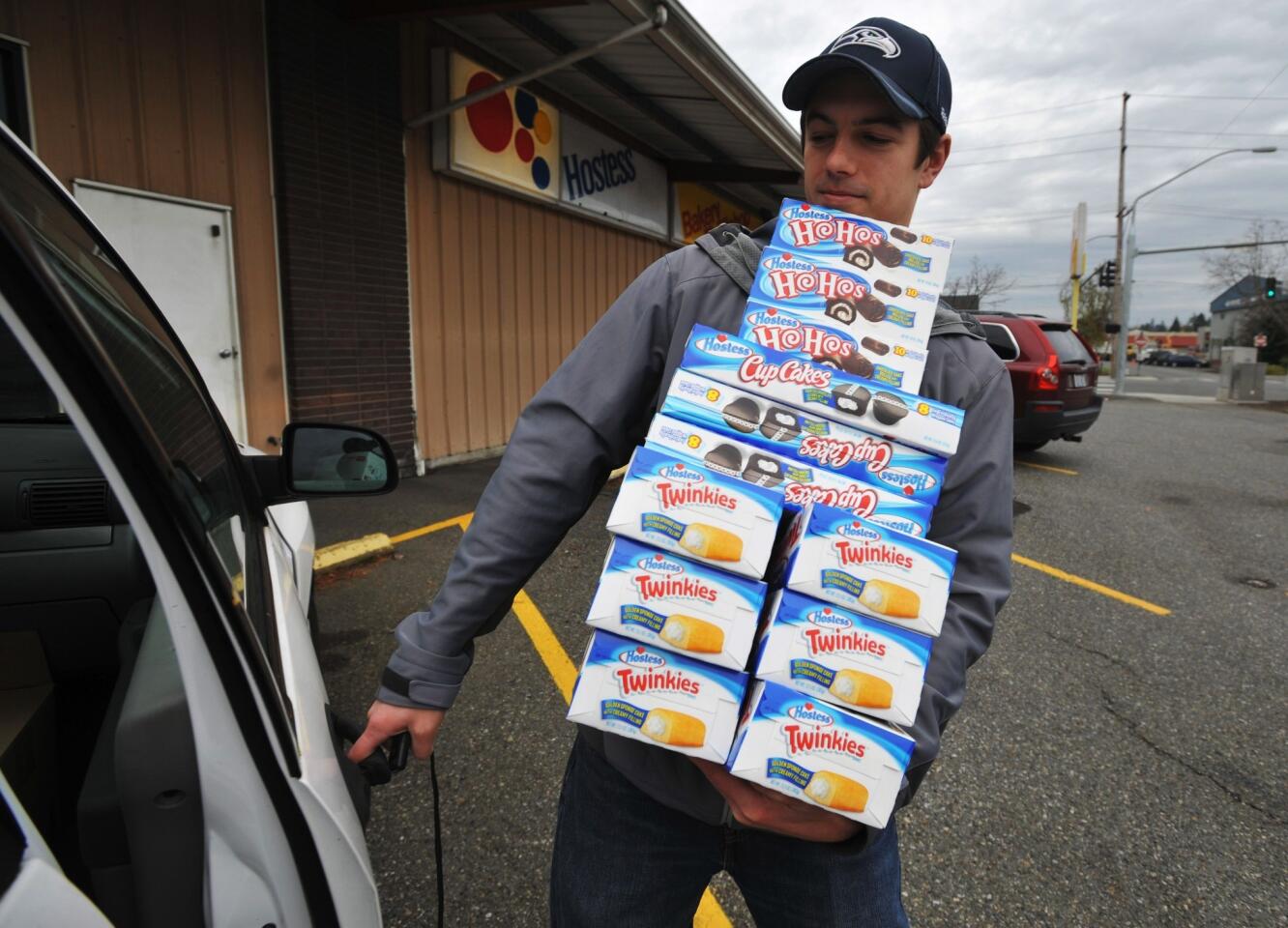 Andy Wagar loads Twinkies, Ho-Hos and Cup Cakes into a van outside the Wonder/Hostess Bakery Thrift Shop in Bellingham, Wash., after Hostess Brands Inc. said it would shut down.