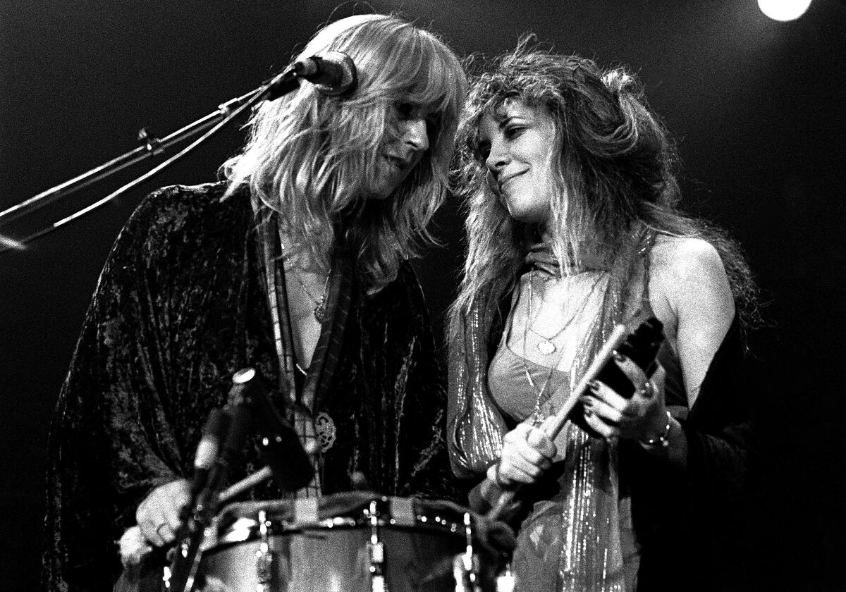Two female singers perform together onstage in 1977.