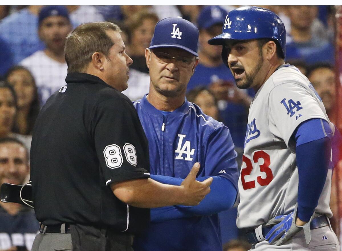 Dodgers first baseman Adrian Gonzalez and Manager Don Mattingly argue the ejection of Gonzalez with umpire Doug Eddings in the seventh inning Friday night in San Diego.