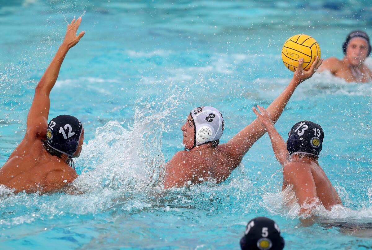 James Rozolis-Hill (8) of Huntington Beach gets position as he shoots and scores against Newport Harbor on Wednesday.