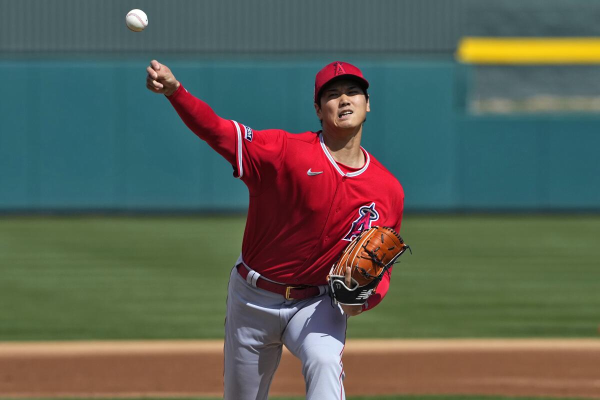 Angels pitcher Shohei Ohtani warms up in between innings of a spring training game