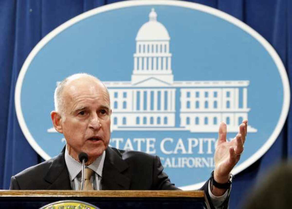 Gov. Jerry Brown discusses his revised state budget plan at a news conference on Monday. He said the budget shortfall swelled from $9.2 billion predicted in January to $16 billion now.