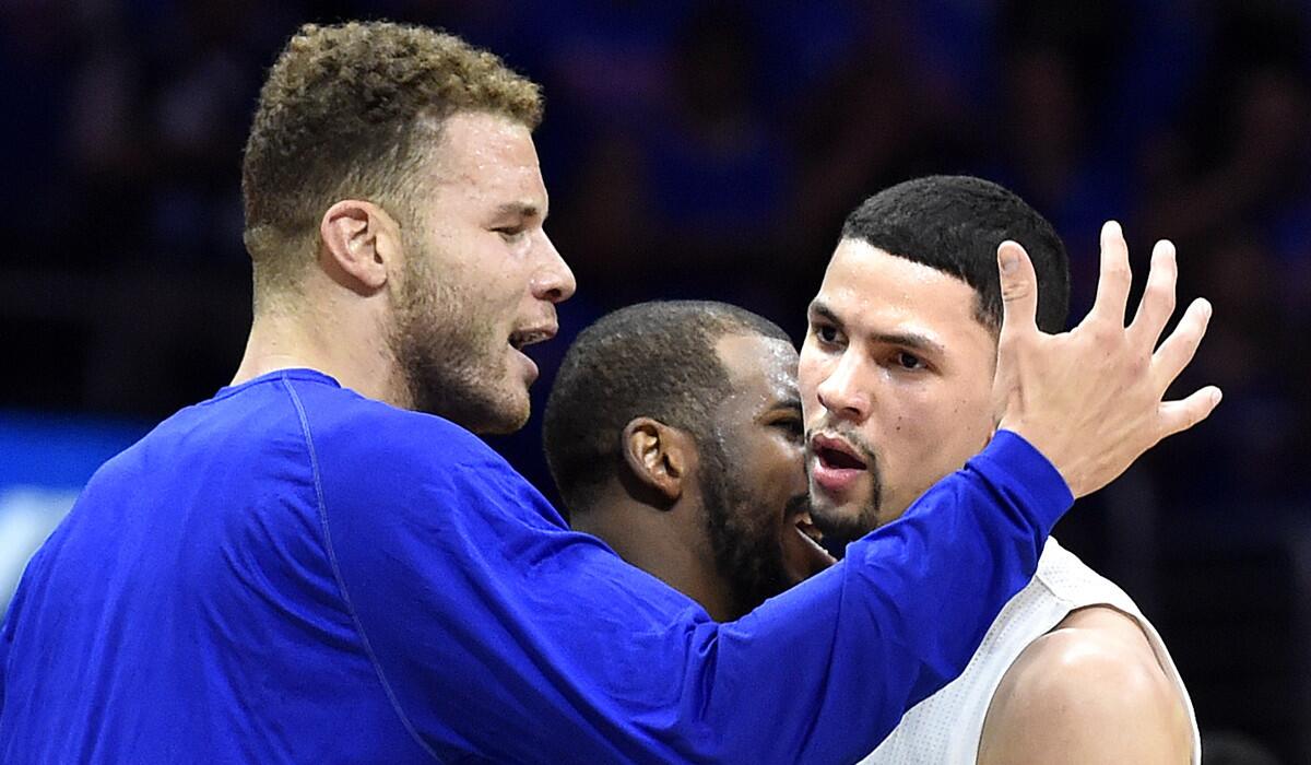 Blake Griffin, left, and Chris Paul come off the bench to congratulate Austin Rivers after his 15-point third quarter Friday against Houston.