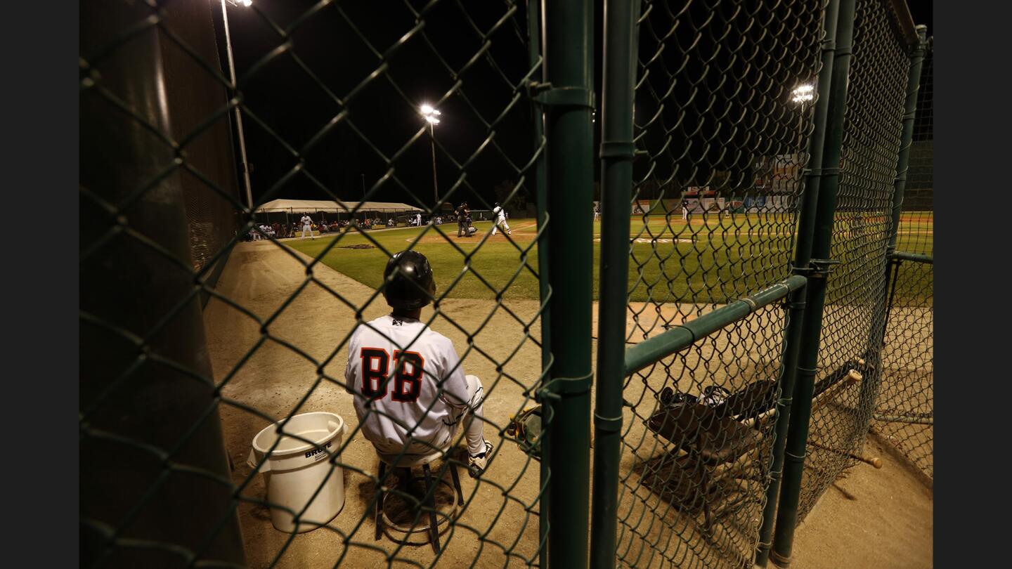 Bakersfield Blaze bat boy Jordan Szolek sits in a corner of the field while watching his team take on the Stockton Ports at Sam Lynn Ballpark.