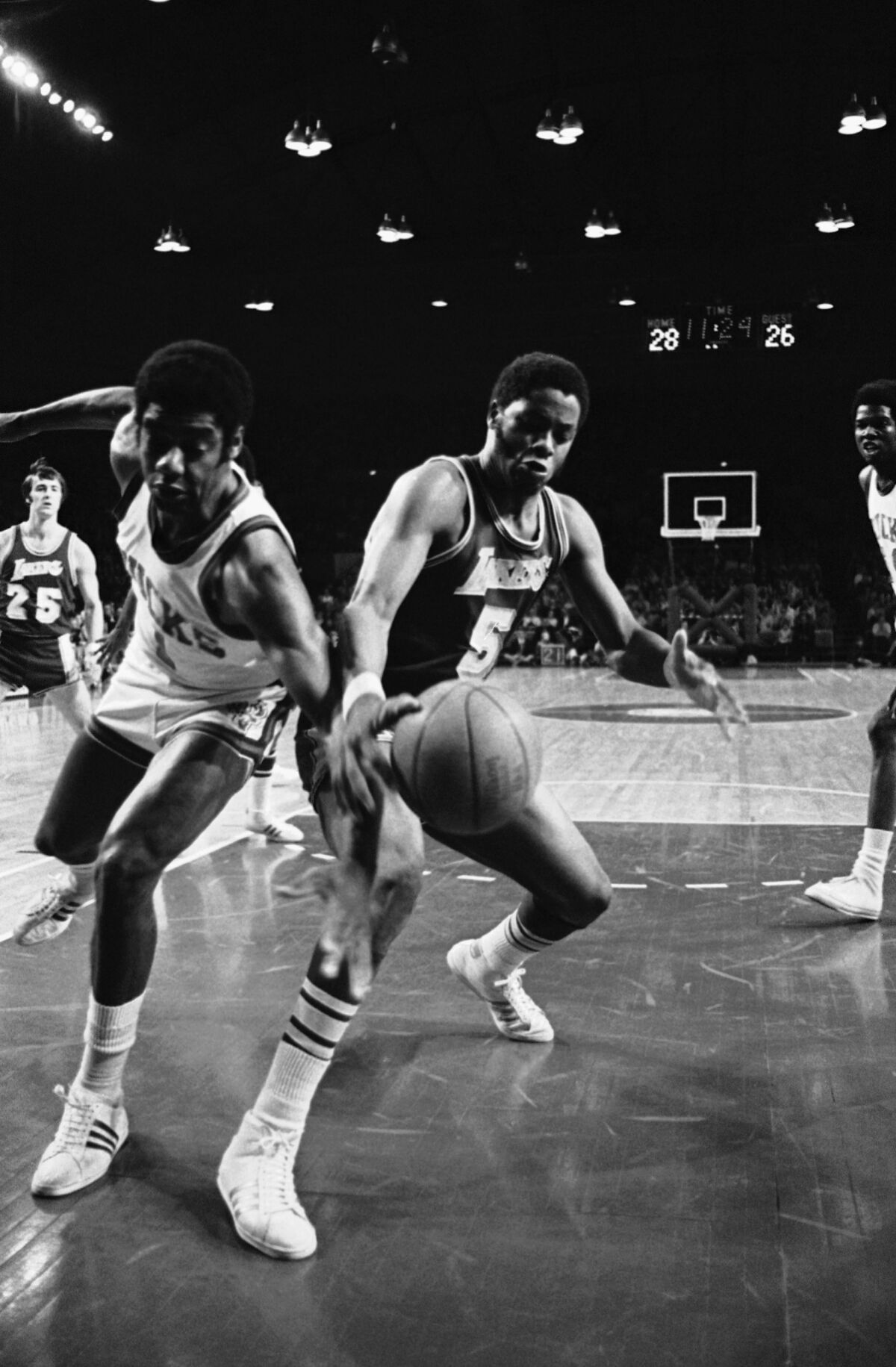 Bucks guard Oscar Robertson tries to steal the ball from Lakers forward Jim McMillian during a 1972 playoff game.