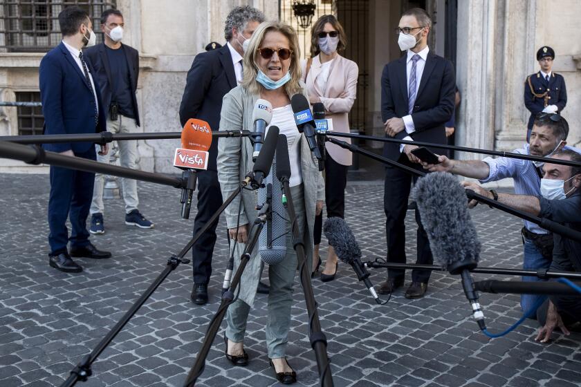 Lead prosecutor Maria Cristina Rota talks with reporters as the leaves Palazzo Chigi premier’s office, in Rome, Friday, June 12, 2020. Italian Premier Giuseppe Conte was being questioned by prosecutors investigating the lack of a coronavirus lockdown of two towns in Lombardy’s Bergamo province that turned into one of the hardest-hit areas of the country's outbreak. (Roberto Monaldo/LaPresse via AP)