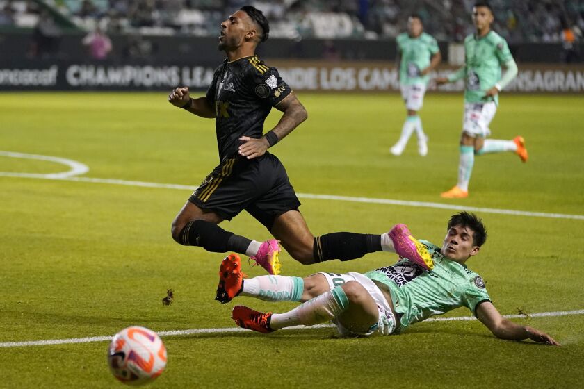 LAFC's Denis Bouanga is tackled by Alfonso Alvarado of Mexico's Leon during the first leg of the CONCACAF championship final 