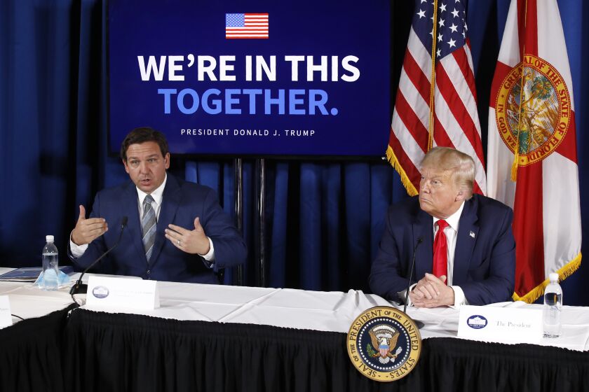 FILE - Florida Gov. Ron DeSantis, left, speaks alongside President Donald Trump during a roundtable discussion on the coronavirus outbreak and storm preparedness at Pelican Golf Club in Belleair, Fla., July 31, 2020. Before Trump and DeSantis were leading rivals for the 2024 Republican presidential nomination, they were allies. (AP Photo/Patrick Semansky, File)