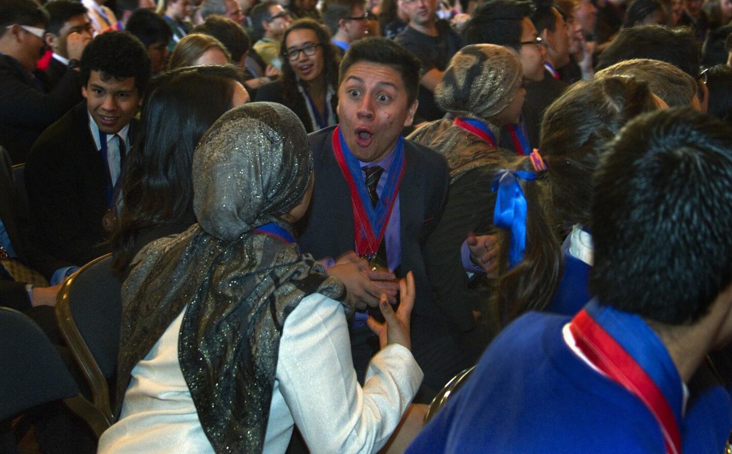 Jose Apolaya of El Camino Real Charter High School, middle, reacts with teammates after the Woodland Hills campus was named winner of the state Academic Decathlon in Sacramento. Granada Hills Charter High, the 2011-13 state and national champion, placed second and John Marshall High School third.