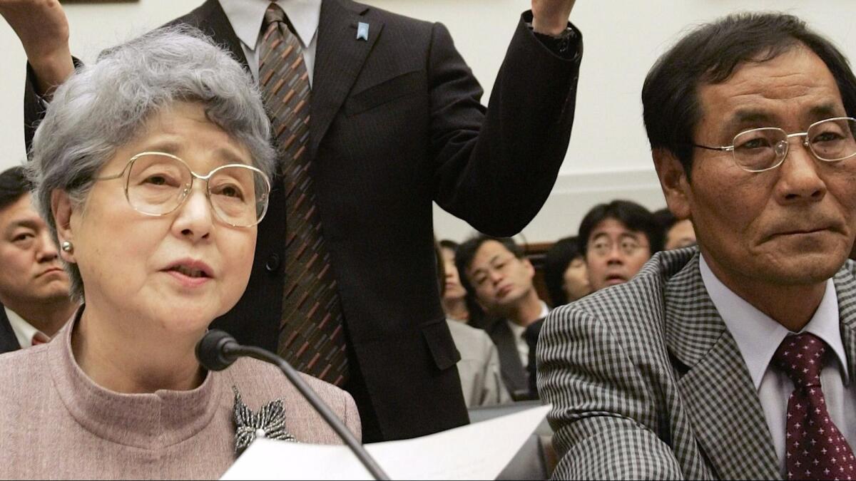 Sakie Yokota testifies before a U.S. House committee in 2006 about the abduction of her daughter, Megumi, by North Korea in 1977. At right is Koh Myung Sup, a South Korean abductee.