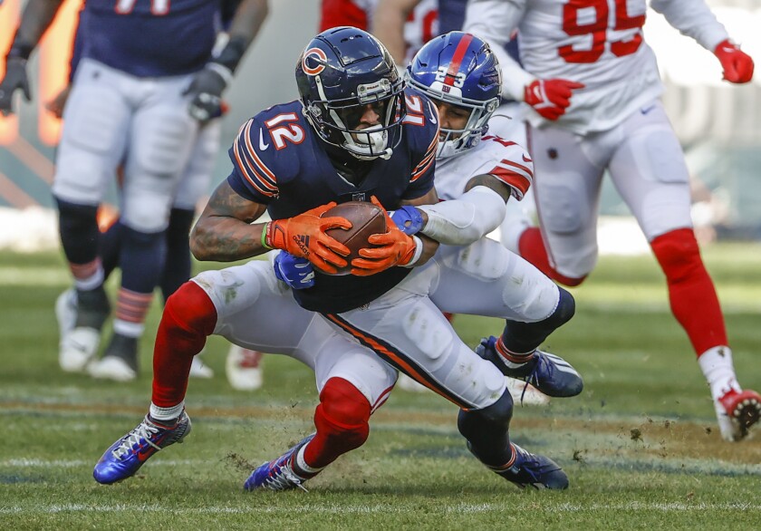 FILE - New York Giants safety Logan Ryan (23) tackles Chicago Bears wide receiver Allen Robinson (12) during the second half of an NFL football game Jan. 2, 2022, in Chicago. Robinson could be on his way out after going from back-to-back seasons with more than 1,100 yards to finishing with 410 playing under the franchise tag. (AP Photo/Kamil Krzaczynski, File)