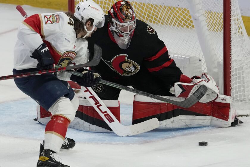 Florida Panthers left wing Ryan Lomberg (94) tries to put a rebound past Ottawa Senators goaltender Mads Sogaard during first-period NHL hockey game action Monday, March 27, 2023, in Ottawa, Ontario. (Adrian Wyld/The Canadian Press via AP)