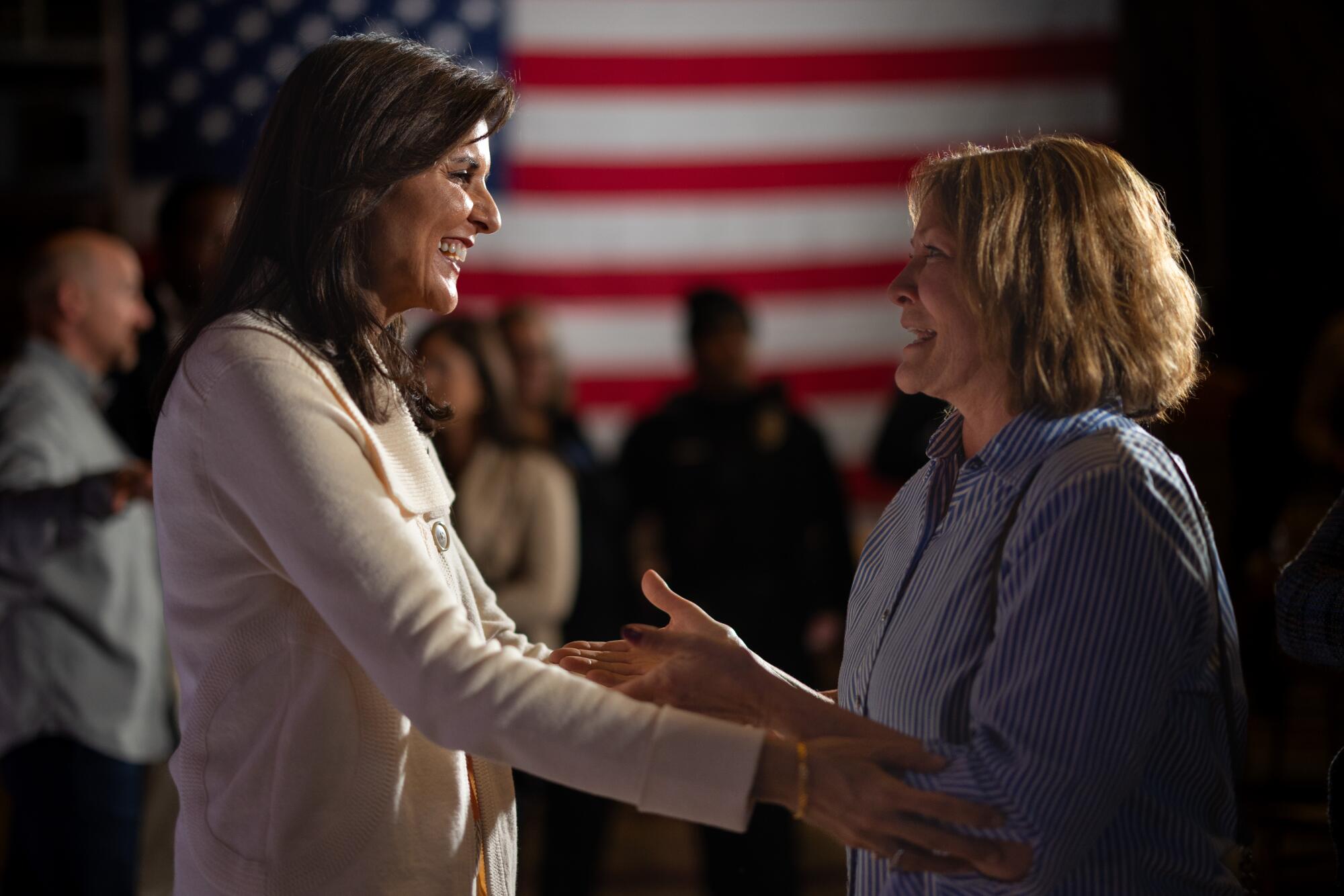 Nikki Haley reaches out to shake hands with a woman