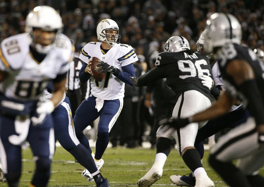 San Diego Chargers quarterback Philip Rivers (17) passes against the Oakland Raiders during the first half of an NFL football game in Oakland, Calif., Thursday, Dec. 24, 2015. (AP Photo/Tony Avelar)