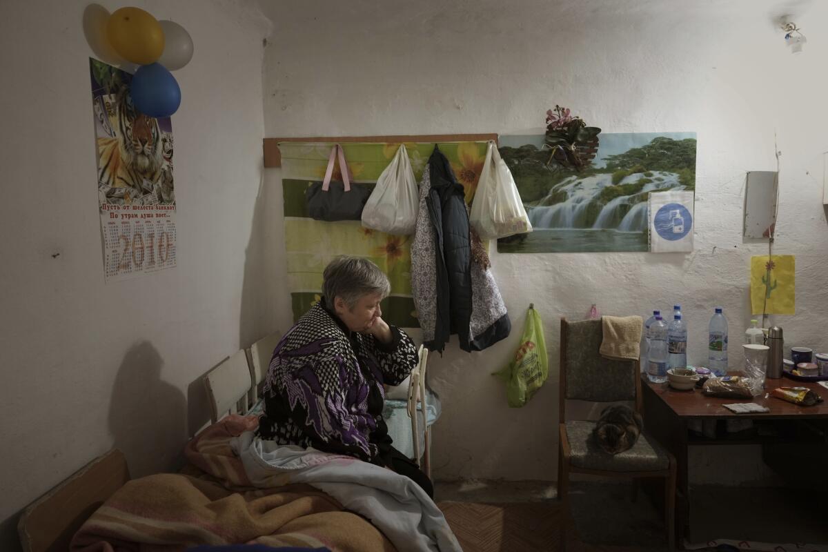 Woman on makeshift bed in a bomb shelter