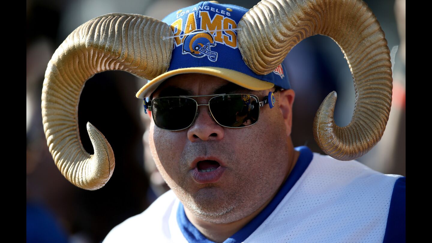A Rams fan watches a joint practice between the Chargers and Rams at UC Irvine.