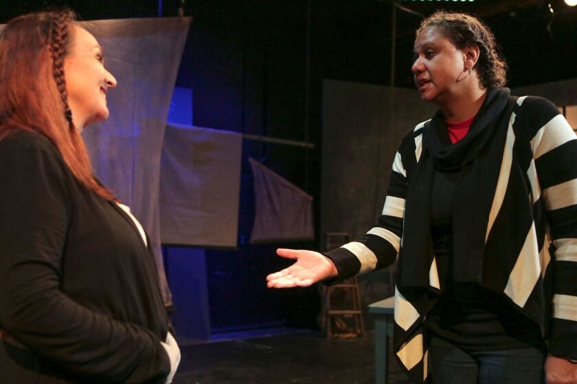Actor LInda Libby (left) and director Jacole Kitchen go over a rehearsal scene from "An Iliad" at New Village Arts.