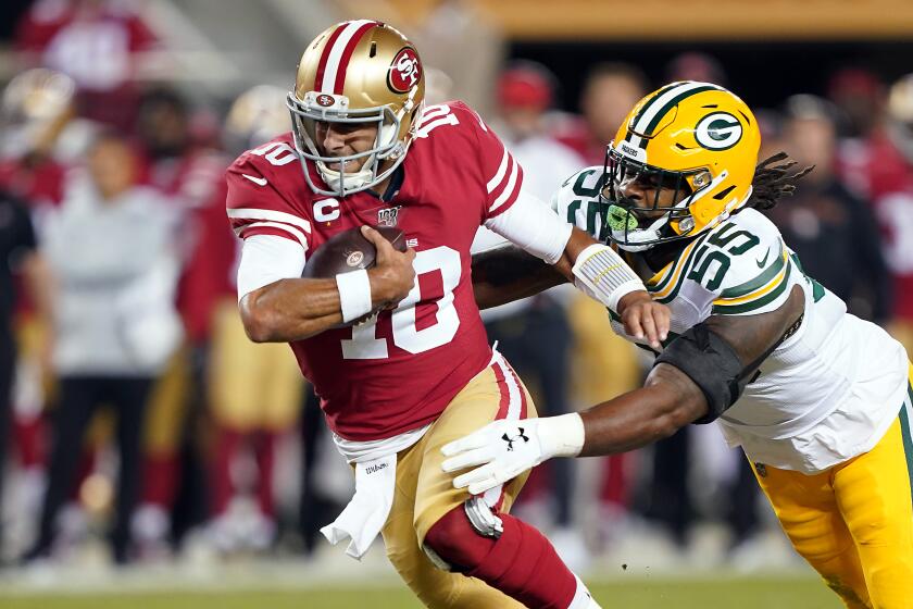 SANTA CLARA, CALIFORNIA - NOVEMBER 24: Quarterback Jimmy Garoppolo #10 of the San Francisco 49ers is chased by outside linebacker Za'Darius Smith #55 of the Green Bay Packers during the first quarter of the game at Levi's Stadium on November 24, 2019 in Santa Clara, California. (Photo by Thearon W. Henderson/Getty Images)