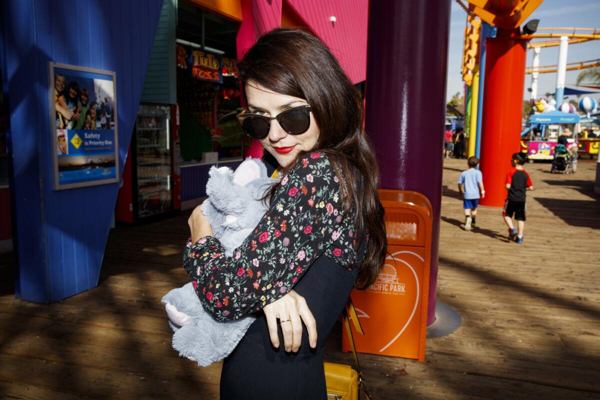 Bleached bassist Micayla Grace celebrates after winning a game of whack-a-mole at the Santa Monica Pier.