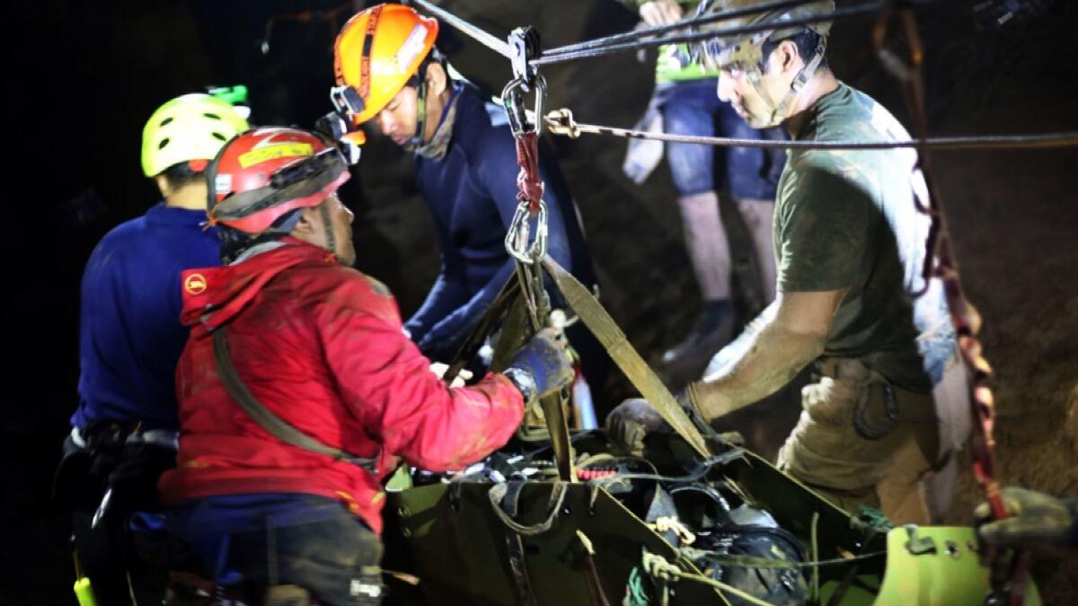 Thai rescuers remove one of the soccer players who was trapped in a cave.