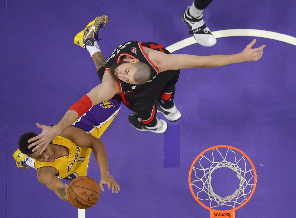 Lakers guard D'Angelo Russell has his layup contested by Raptors center Jonas Valanciunas in the first half.