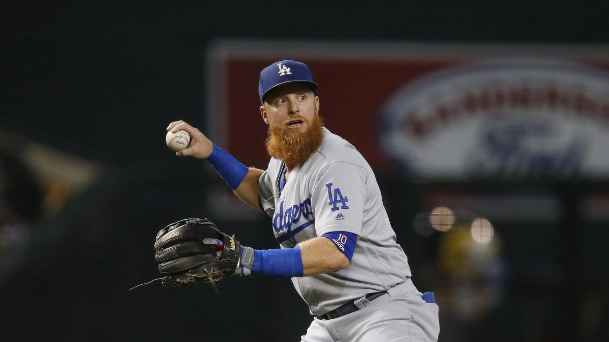 Dodgers third baseman Justin Turner gets set to throw to first base against the Arizona Diamondbacks during the first inning on Sept. 1 in Phoenix.