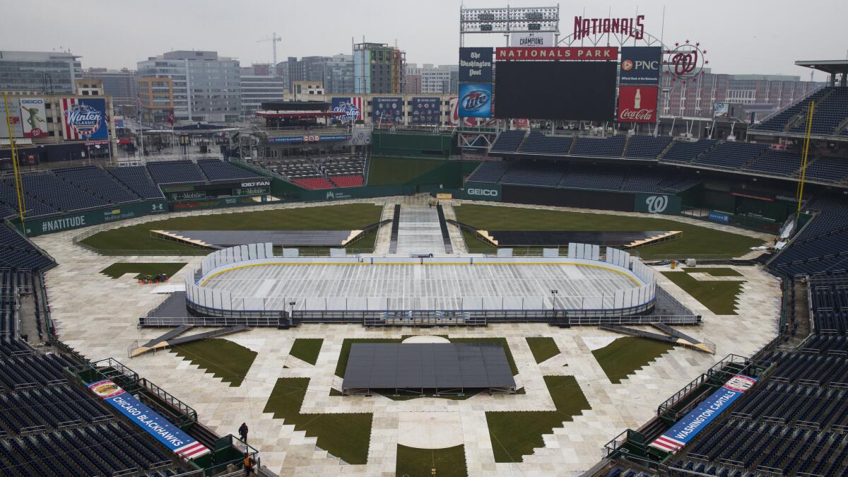 Construction crews work on preparing an outdoor hockey rink at Nationals Park for the New Year's Day game between the Washington Capitals and Chicago Blackhawks.