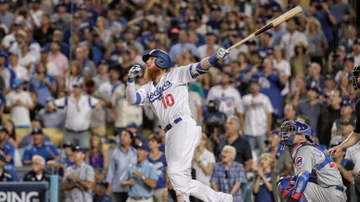 Justin Turner watches the ball sail over the fence for a game-winning, three-run home run to beat the Cubs in Game 2 of the NLCS.