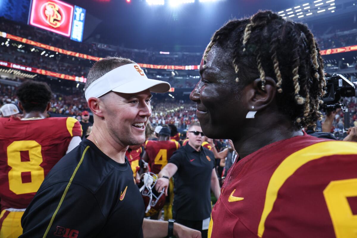 USC coach Lincoln Riley congratulates defensive end Anthony Lucas as they celebrate a 27-20 win over LSU.