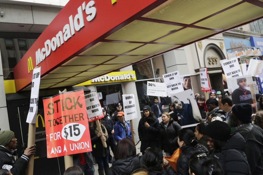 Dozens of fast-food workers and supporters protest workplace conditions in front of a McDonald's restaurant in New York on March 17.