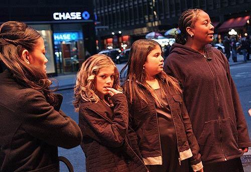 Isaiah House Music Club members wait outside their New York hotel before their performance at Carnegie Hall -- 2,800 miles away from their homeless shelter in Santa Ana. They are, from second from left, Tiffany Zoller, Serena Escamilla and Jasmine Bush.