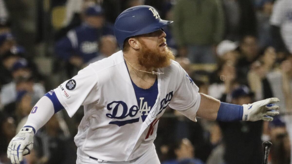 Justin Turner hits the second of his three homers in the fifth inning against the Atlanta Braves on Tuesday at Dodger Stadium. He came into the game with one.
