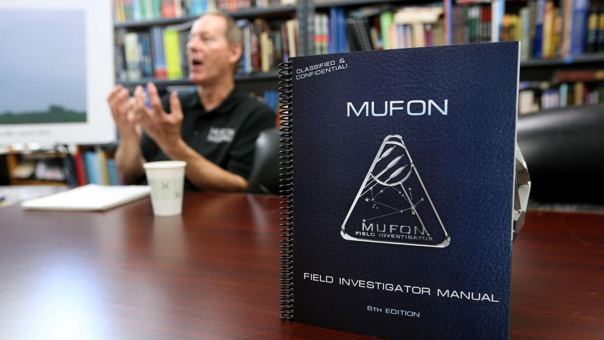 Jan Harzan explains UFO theory at the Mutual UFO Network (MUFON) world headquarters in Irvine.