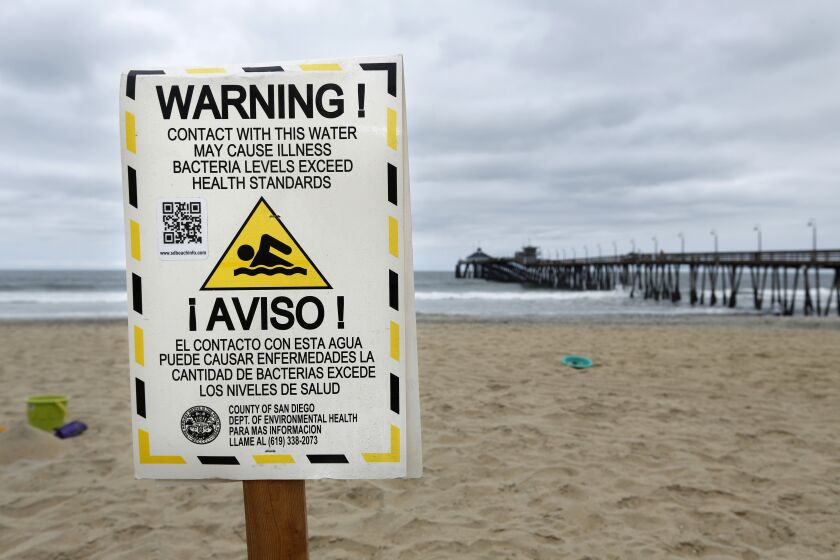 Signs warn beachgoers in Imperial Beach of high bacteria levels in the water which is often due to sewage from Tijuana. (Photo by K.C. Alfred/ San Diego Union -Tribune