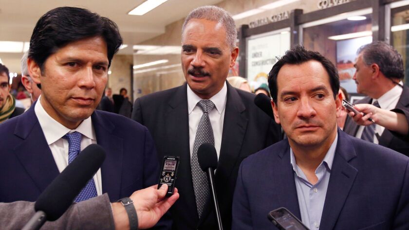 California Senate President Pro Tem Kevin de León (D-Los Angeles), left, and Assembly Speaker Anthony Rendon (D-Paramount) talk to reporters in Sacramento with former U.S. Atty. Gen. Eric Holder — part of an effort to blunt the impact of proposals from the Trump administration.