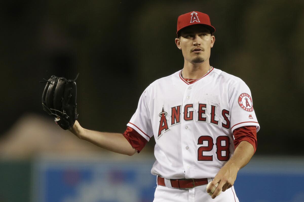 Angels pitcher Andrew Heaney calls a trainer to the mound as he suffers a nose bleed while pitching against the Chicago Cubs on April 5, 2016.