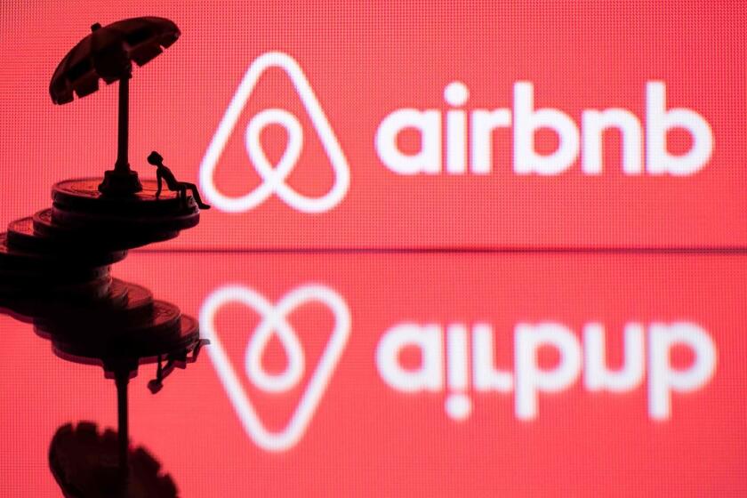 (FILES) In this file illustration photo taken on August 29, 2018 taken in Paris shows a toy umbella and a figurine on coins next to the logo of rental website Airbnb. - Airbnb on February 7, 2019 said that it hired airline industry veteran Fred Reid away from an autonomous flight vehicle startup backed by Google co-founder Larry Page.The move was described as part of an effort by the San Francisco based firm to add "how you get there" to an Airbnb platform that already features lodging and activities. (Photo by JOEL SAGET / AFP)JOEL SAGET/AFP/Getty Images ** OUTS - ELSENT, FPG, CM - OUTS * NM, PH, VA if sourced by CT, LA or MoD **