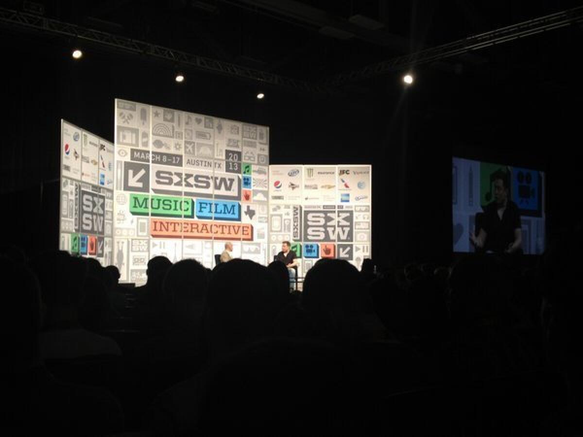 Elon Musk, right, talks about the latest SpaceX rocket launch during his keynote at South by Southwest.