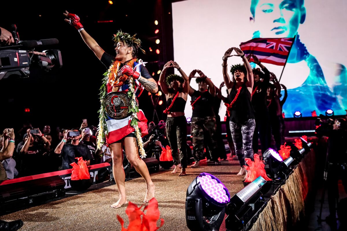Ilima-Lei Macfarlane makes her entrance for her title defense at Bellator 236 with supporters in the background.
