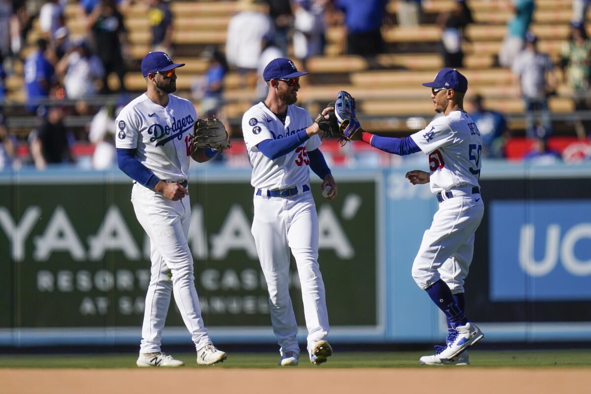 Dodgers outfielders Joey Gallo, Cody Bellinger and Mookie Betts celebrate after a 4-1 win.