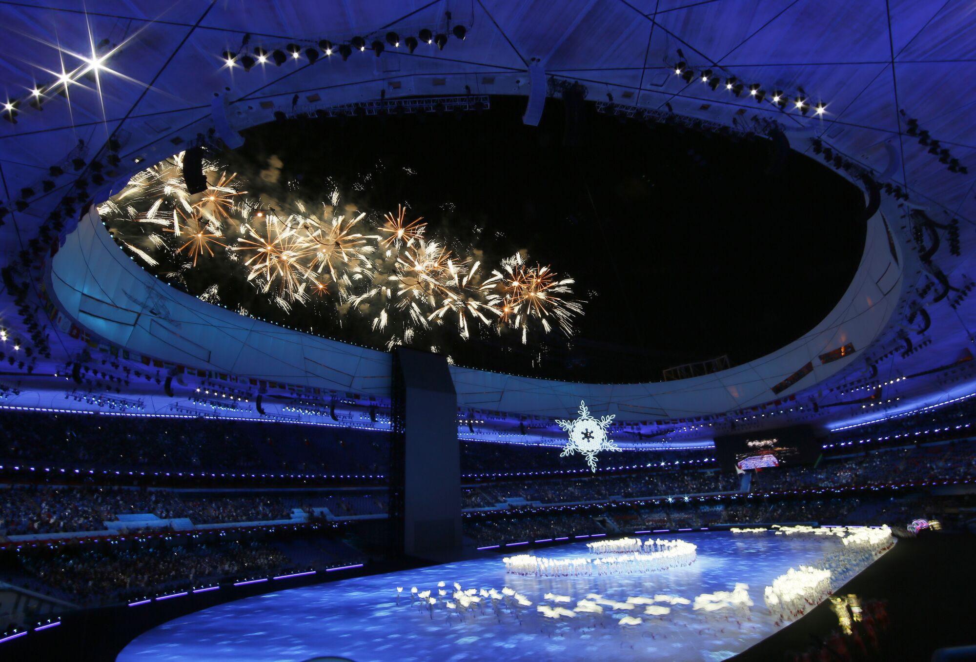 Fireworks explode over Beijing National Stadium during the 2022 Winter Olympics opening ceremony.