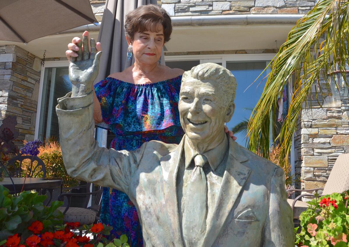 Miriam Baker with her creation of former President Ronald Reagan bronze sculpture.