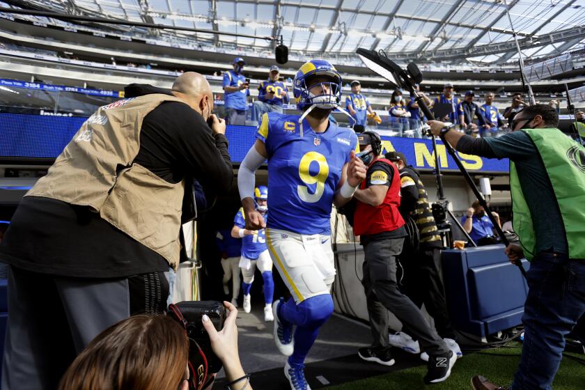 INGLEWOOD, CA - JANUARY 9, 2022: Los Angeles Rams quarterback Matthew Stafford (9) runs onto the field for pre-game warmups before facing the San Francisco 49ers on January 9, 2022 at SoFi Stadium in Inglewood, California.(Gina Ferazzi / Los Angeles Times)