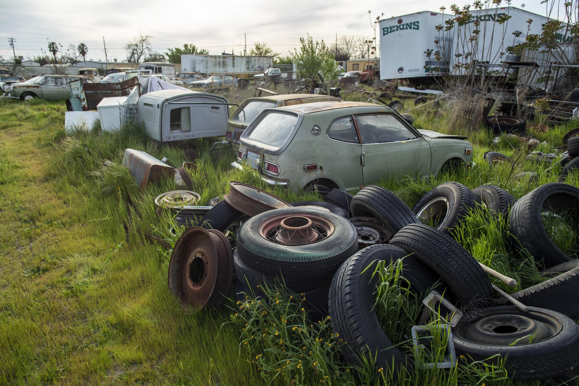 Old cars, junk and antiques sit in a lot in Turlock.