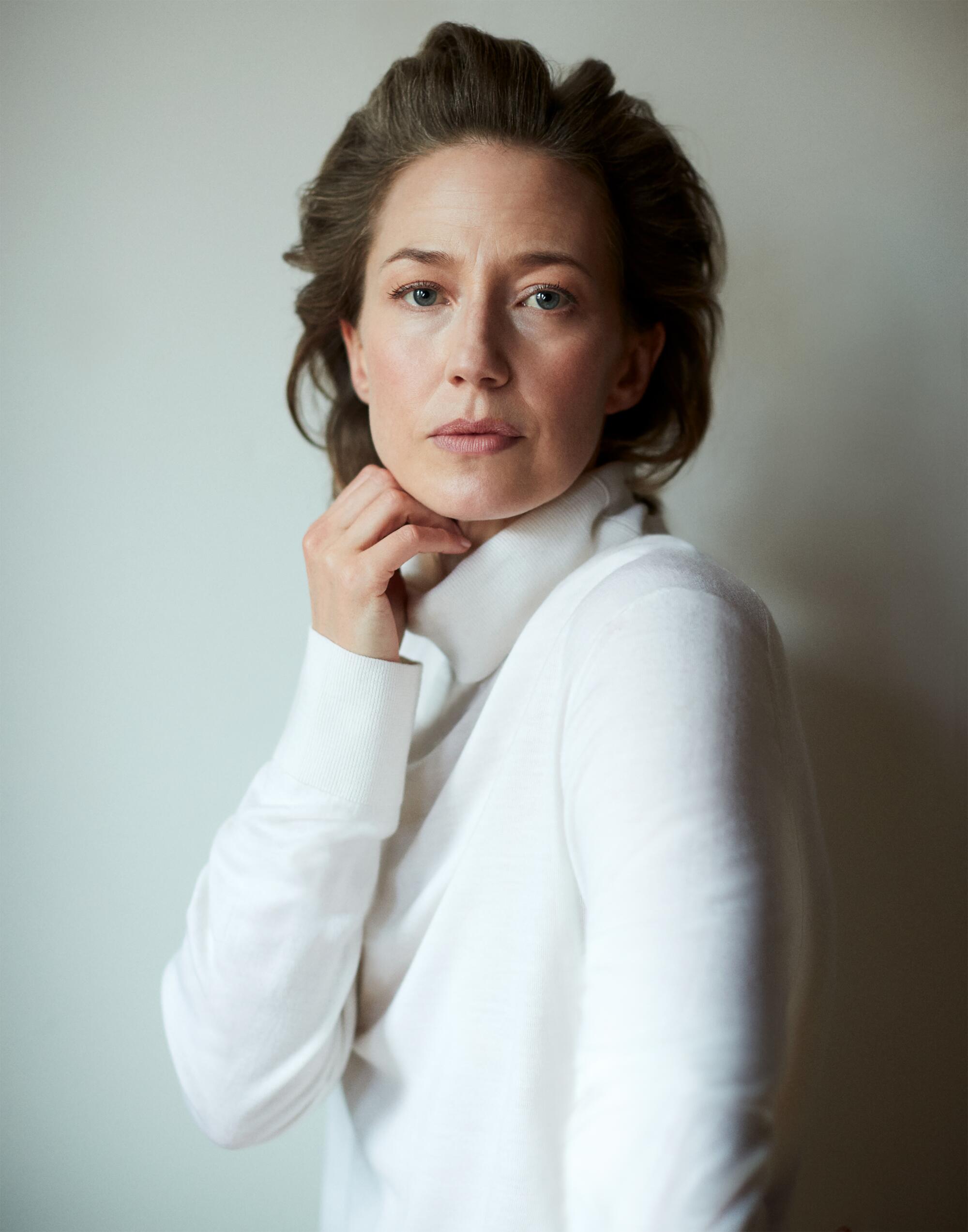 Carrie Coon puts a hand to her chin for a portrait.