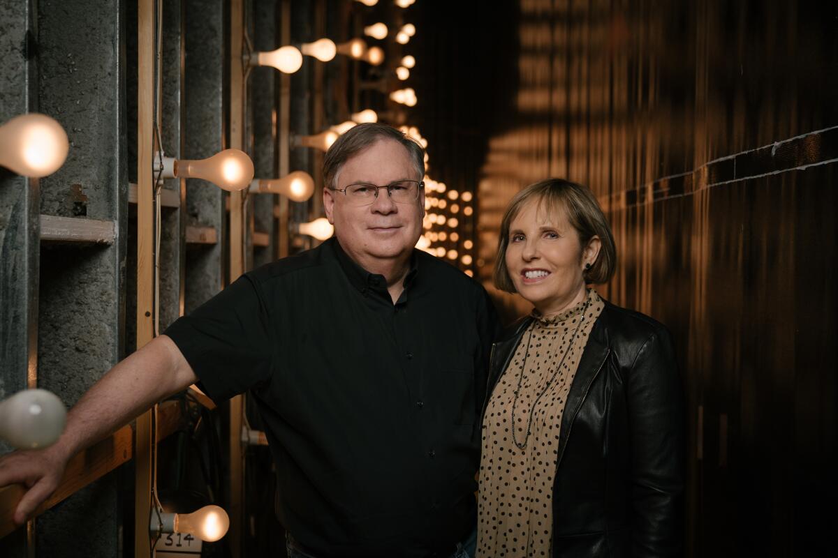 Robert and Michelle King pose on a soundstage