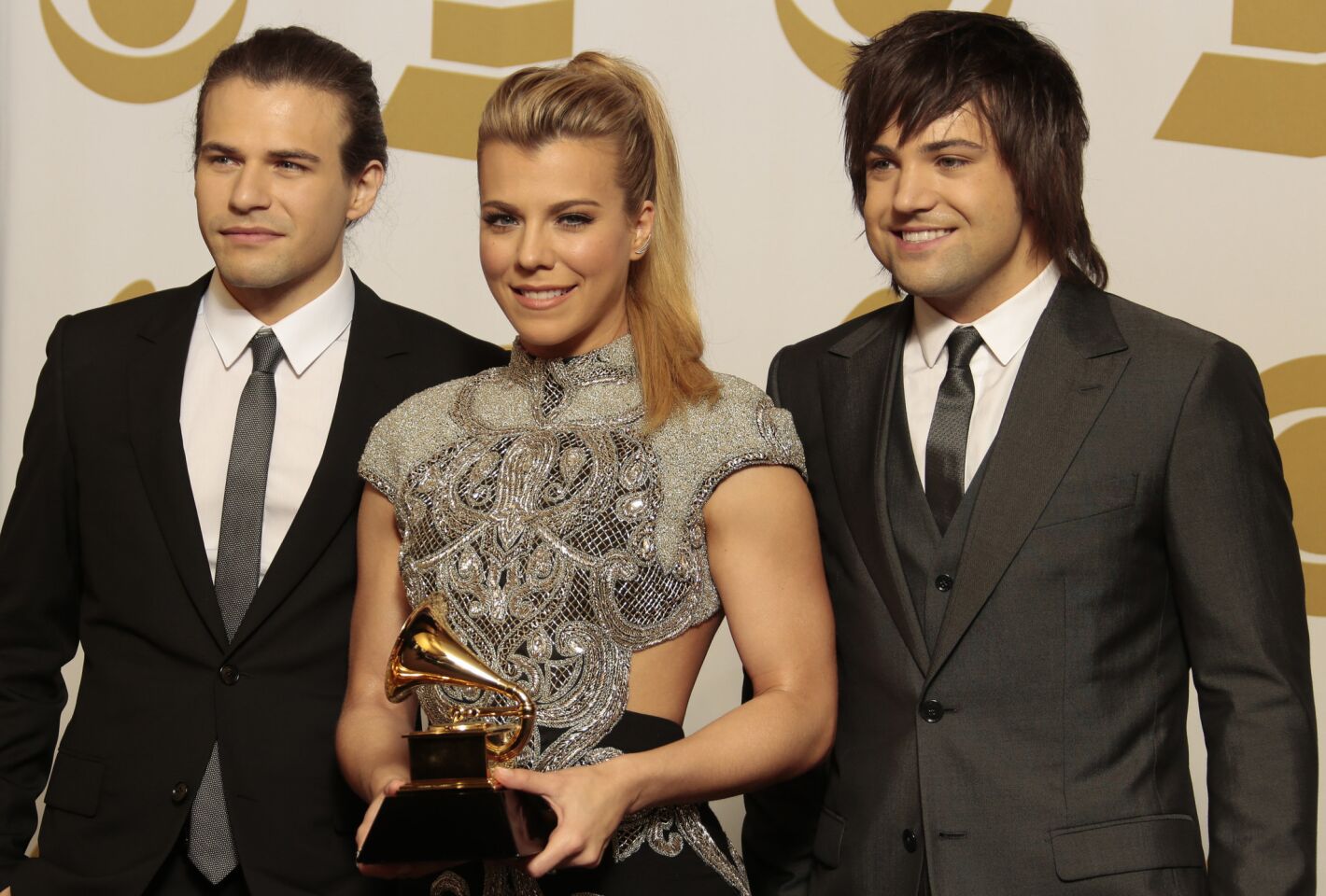 Neill Perry, left, Kimberly Perry and Reid Perry of the Band Perry hold their Grammy Award for country duo/group performance for "Gentle On My Mind."